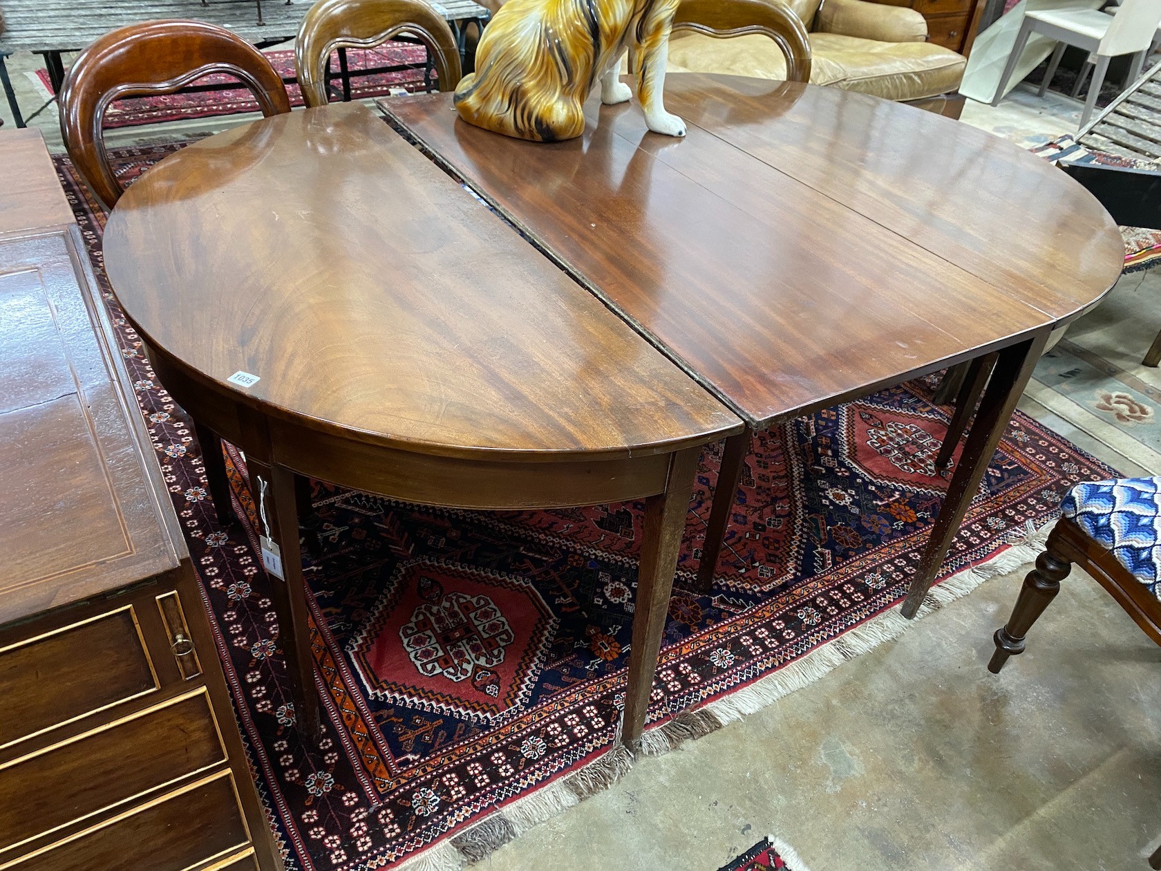 A George III mahogany D end extending dining table with later drop leaf, 180cm extended, depth 127cm, height 74cm